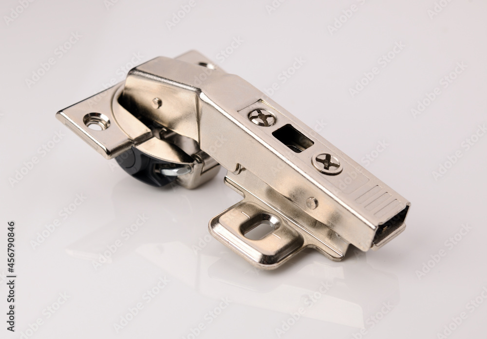 New kitchen cabinet hinge on a white background. New kitchen cabinet hinge on a white background.