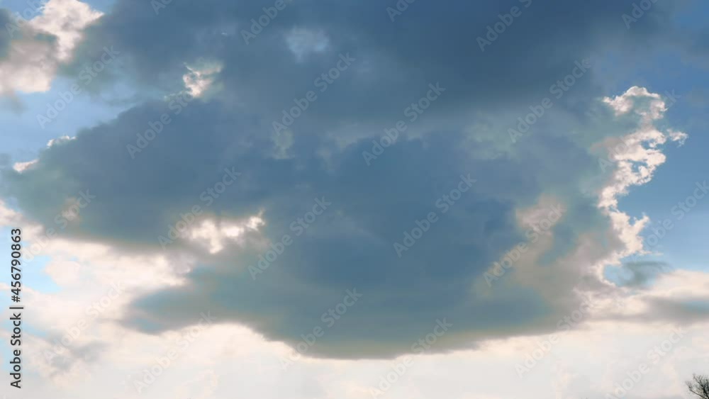 Time-lapse of a cloud starting to show the sun behind it Time-lapse of a cloud starting to show the sun behind it