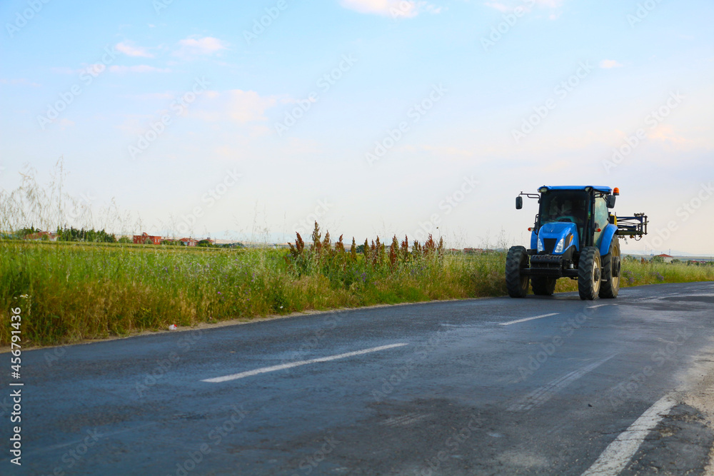 selective focus, big blue tractor used by farmers in fields