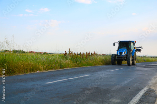 selective focus, big blue tractor used by farmers in fields