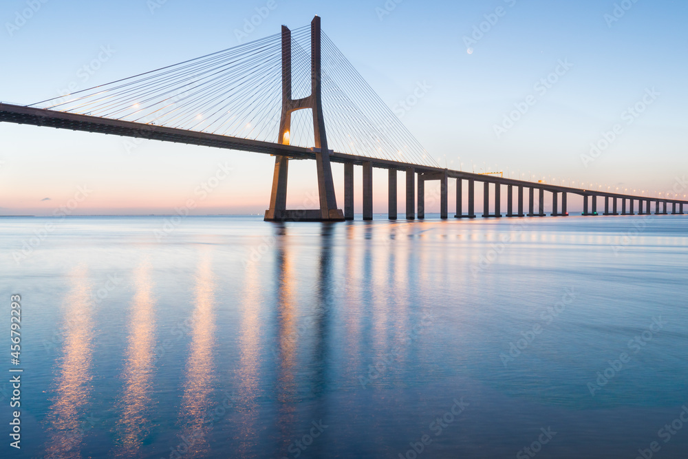 Fototapeta premium Amazing sunrise in Lisbon, watching the Vasco da Gama Bridge start to light up