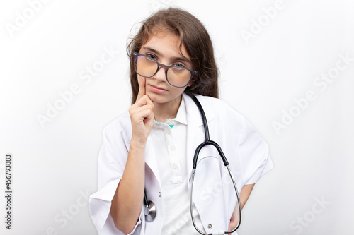 Thoughtful little girl in doctor's costume.