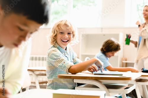 Funny interesting class lesson with teacher. Pupils schoolchildren classmates students involved in learning process. Attendancy concept © InsideCreativeHouse