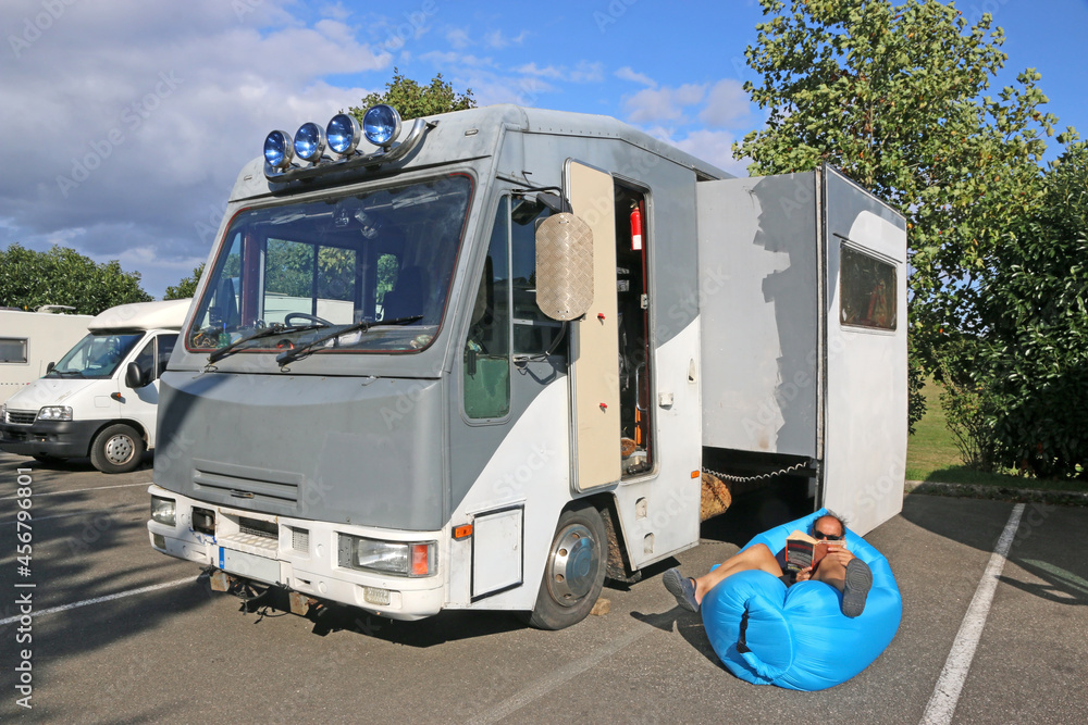 Man relaxing by his motorhome
