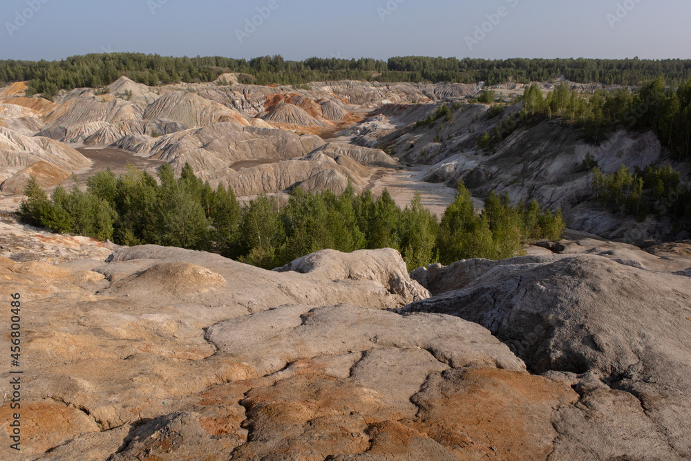 Obraz premium The clay quarry resembles a cosmic landscape.Ural Mars.An original landscape in the Sverdlovsk region in Russia.Top view of the hills made of refractory clay.A unique place created by man and nature