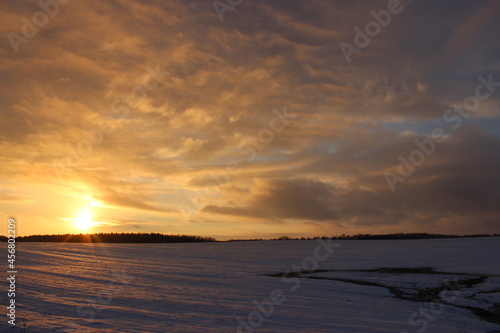 Winter landscape with a beautiful sunset over the field