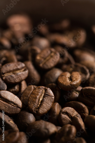 Coffee beans close-up. Macro photography of coffee on a brown background. A place for text in food photos. Arabica.