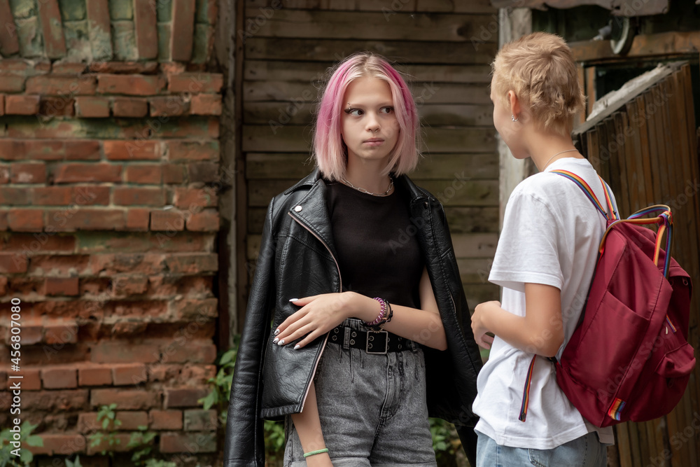 two teenage girls are secret in the courtyard of an old house two teenage girls are secret in the courtyard of an old house