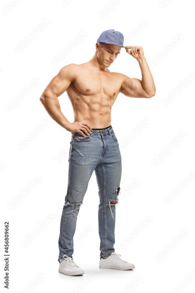 Full length shot of a topless man in jeans and a cap Full length shot of a topless man in jeans and a cap