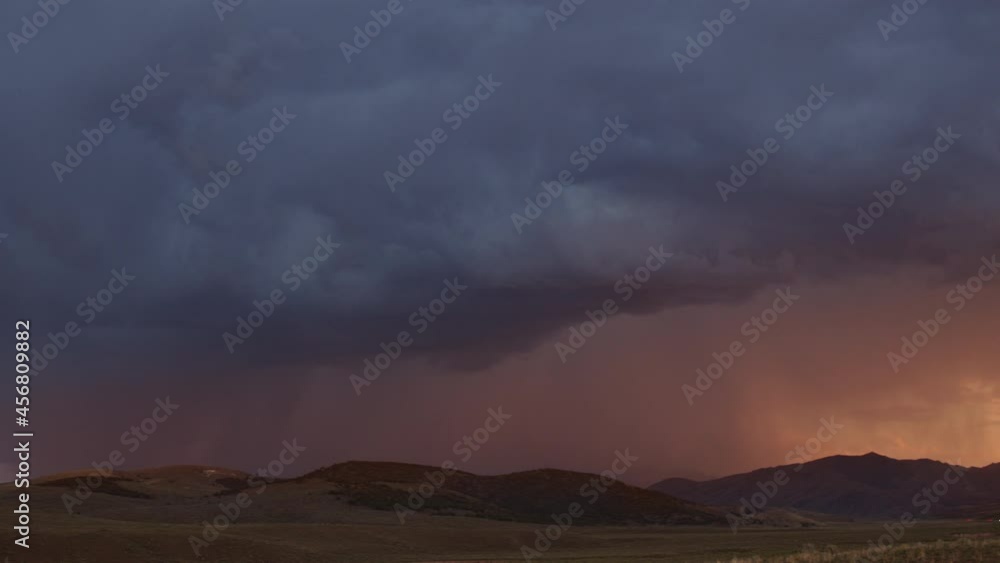 Lightning bolts flashing through the sky at sunset panning over the horizon in Utah. Lightning bolts flashing through the sky at sunset panning over the horizon in Utah.