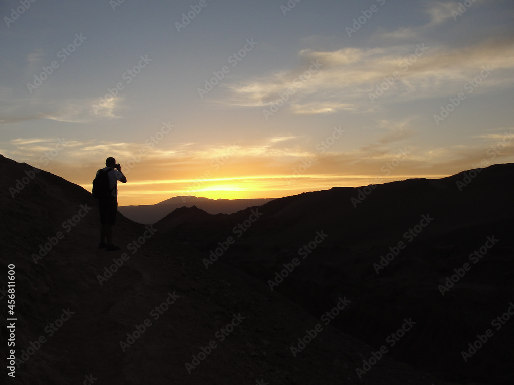 Man taking pictures of the sunset in Valle de la Luna, Atacama Desert, Chile.