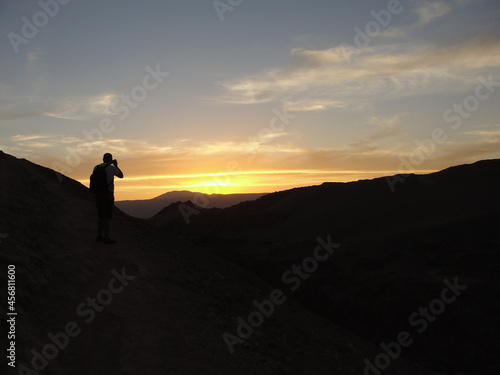 Man taking pictures of the sunset in Valle de la Luna, Atacama Desert, Chile.