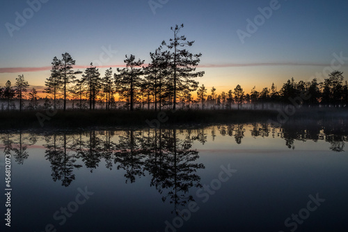 Fog over the lake. Fog over the forest. Fog over the swamp. Sunset. Dawn. Northern nature. Summer and autumn nature. Beautiful landscape. © kareliatim