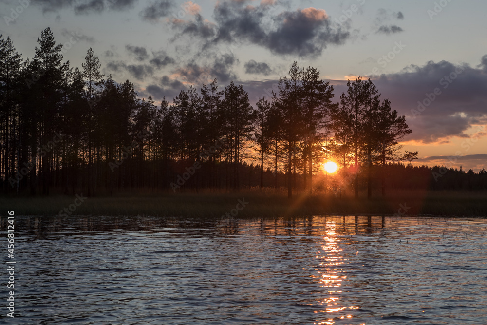 Sunset over the lake. Low sun, beautiful sky. Lake and forest. Sunset over the lake. Low sun, beautiful sky. Lake and forest.