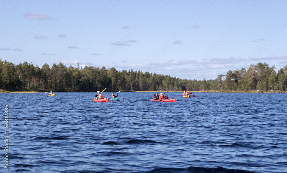 Kayaks on the lake. Tourists go canoeing. Canoes and kayaks on the water. Alloy. Lake. The nature of the north.