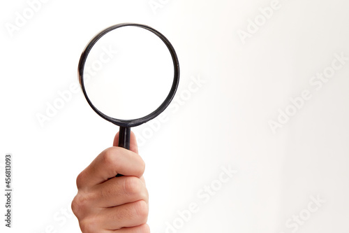 man holding magnifying glass on white background