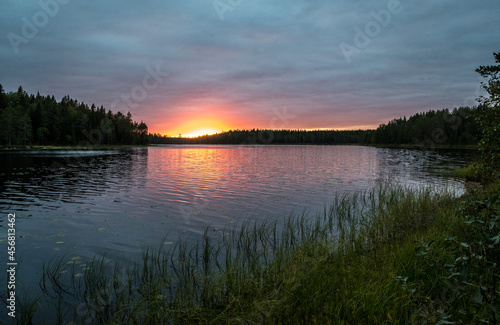 Northern nature. Panorama of the forest. Lake, forest, river. Beautiful landscape with lake and forest. Sunset and sunrise. Reflection of the forest in the water.