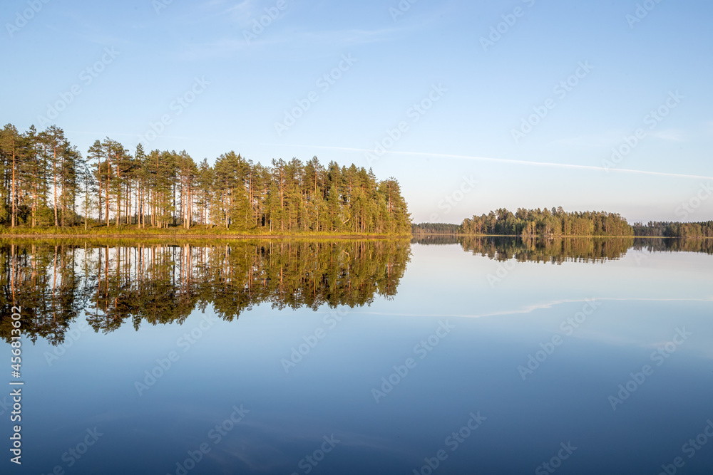 Fototapeta premium Northern nature. Panorama of the forest. Lake, forest, river. Beautiful landscape with lake and forest. Sunset and sunrise. Reflection of the forest in the water.