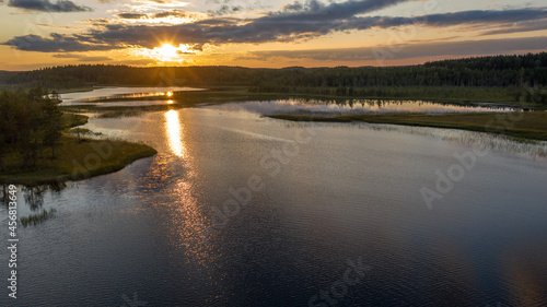 Northern nature. Panorama of the forest. Lake  forest  river. Beautiful landscape with lake and forest. Sunset and sunrise. Reflection of the forest in the water.
