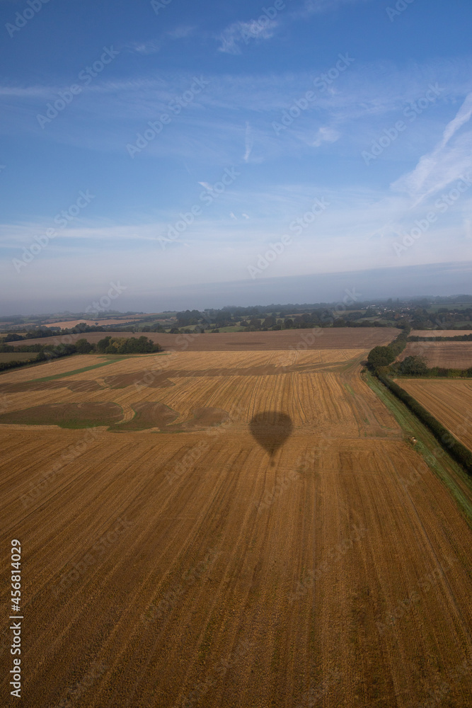 Obraz premium Aerial images of Wiltshire England taken from a hot air balloon. A cold and foggy morning flying over the recently harvested fields. 