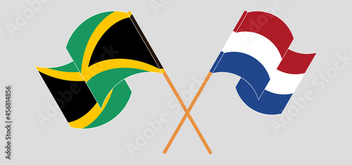 Crossed and waving flags of Jamaica and the Netherlands