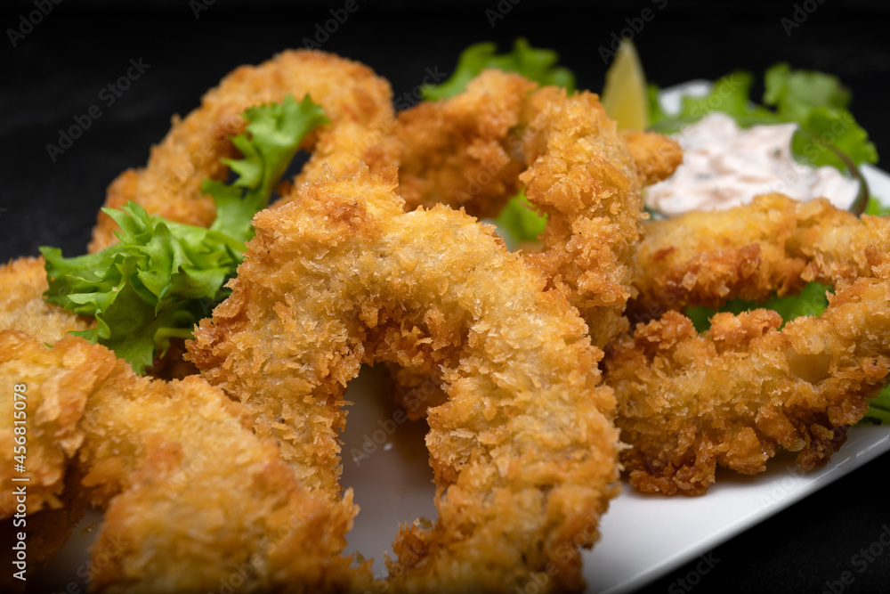Squid rings fried in batter on a dark background soft focus Squid rings fried in batter on a dark background soft focus