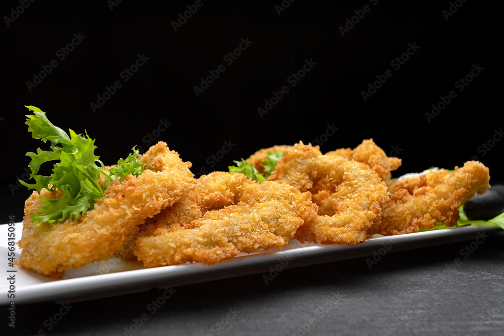 Squid rings fried in batter on a dark background soft focus Squid rings fried in batter on a dark background soft focus