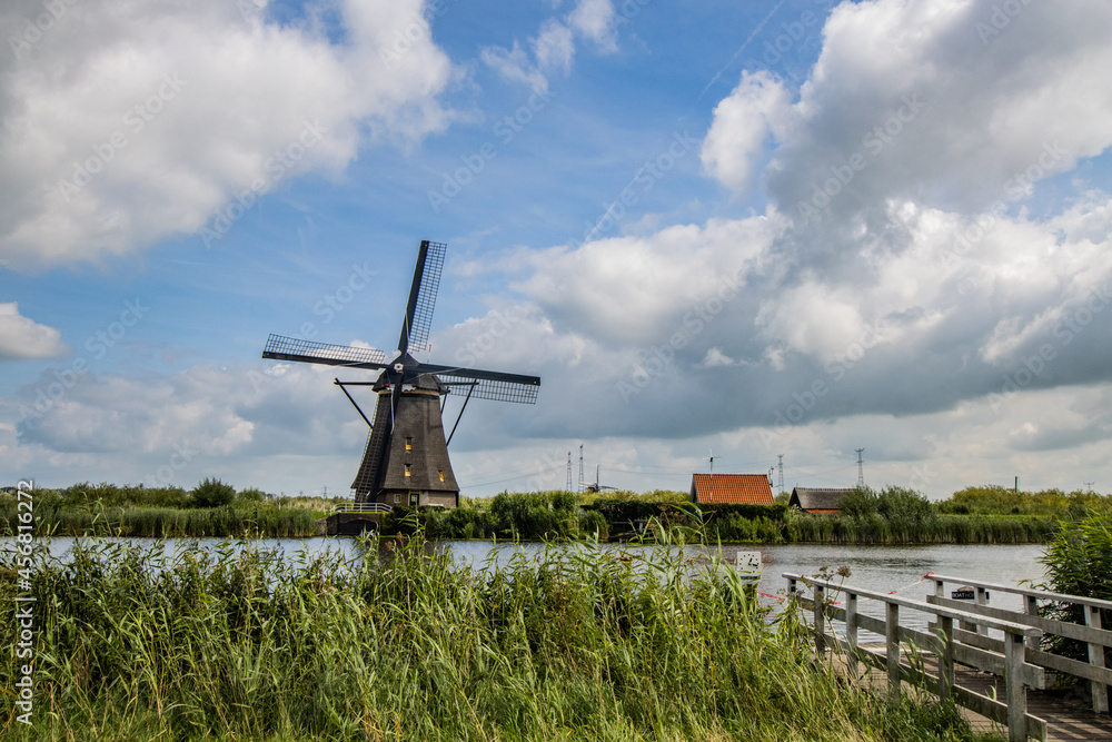 Traditional ancient windmills in the Dutch countryside. Outdoor tours and family bike tours in the Dutch countryside among the windmills Traditional ancient windmills in the Dutch countryside. Outdoor tours and family bike tours in the Dutch countryside among the windmills