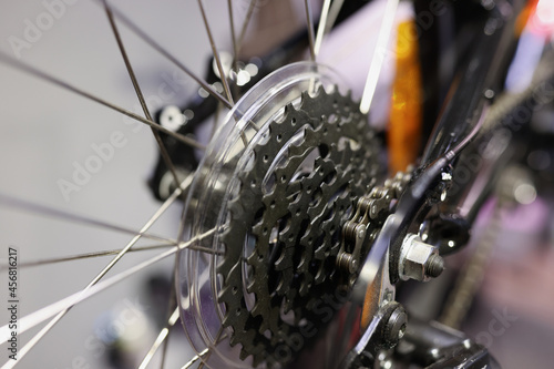 Closeup of metal bicycle cassette with chain on wheel