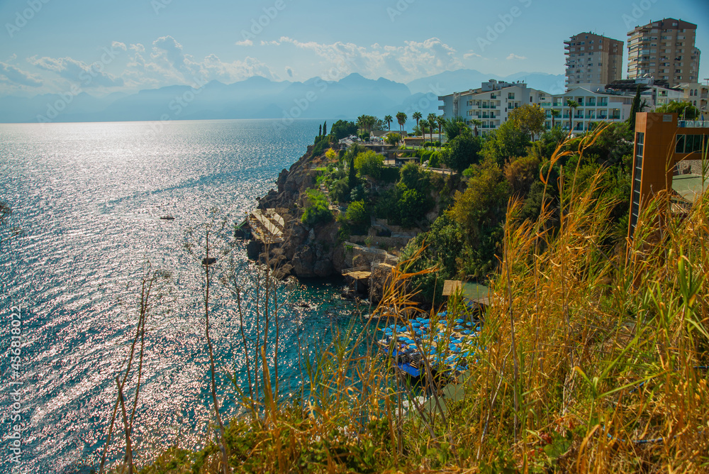 ANTALYA, TURKEY: View of a small beach in the rocks in the Turkish city of Antalya on a sunny summer day.