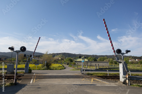 Fototapeta Level crossing with a barrier on a railroad track in Valga, Galicia, Spain