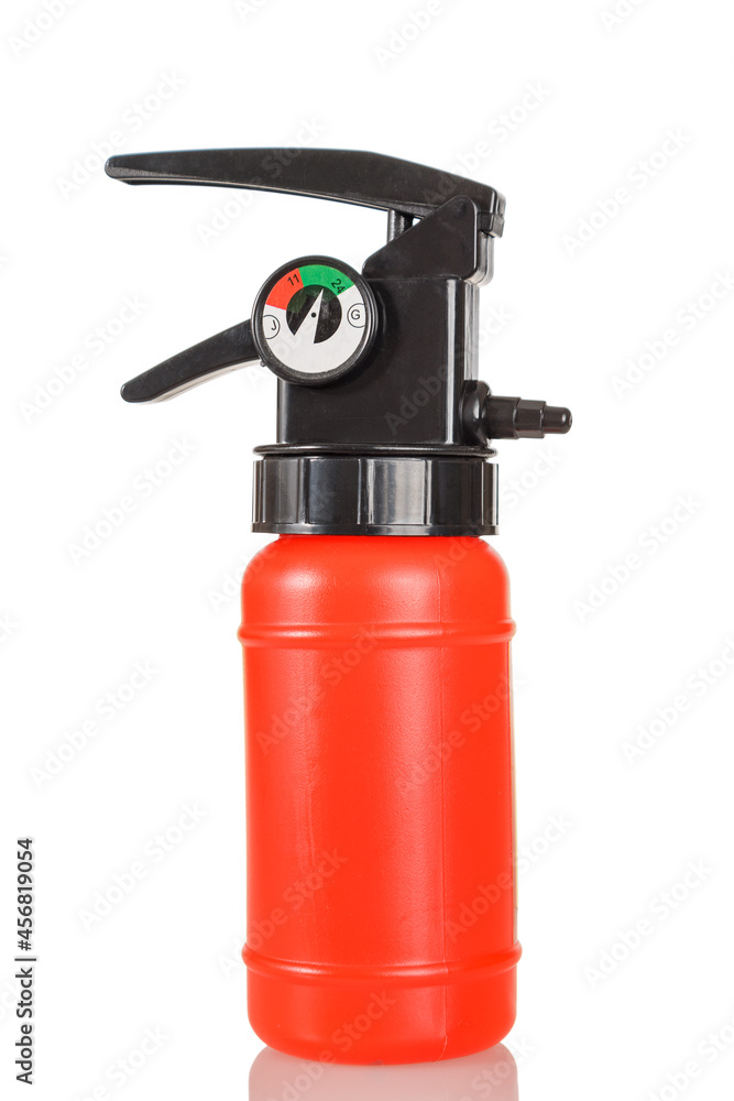 Toy fire extinguisher plastic red color, isolated on a white background, close-up