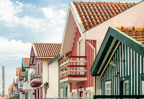 Rainbow colored typical little houses of different architectural styles with red roof tiles at famous Costa Nova street in Aveiro, Portugal