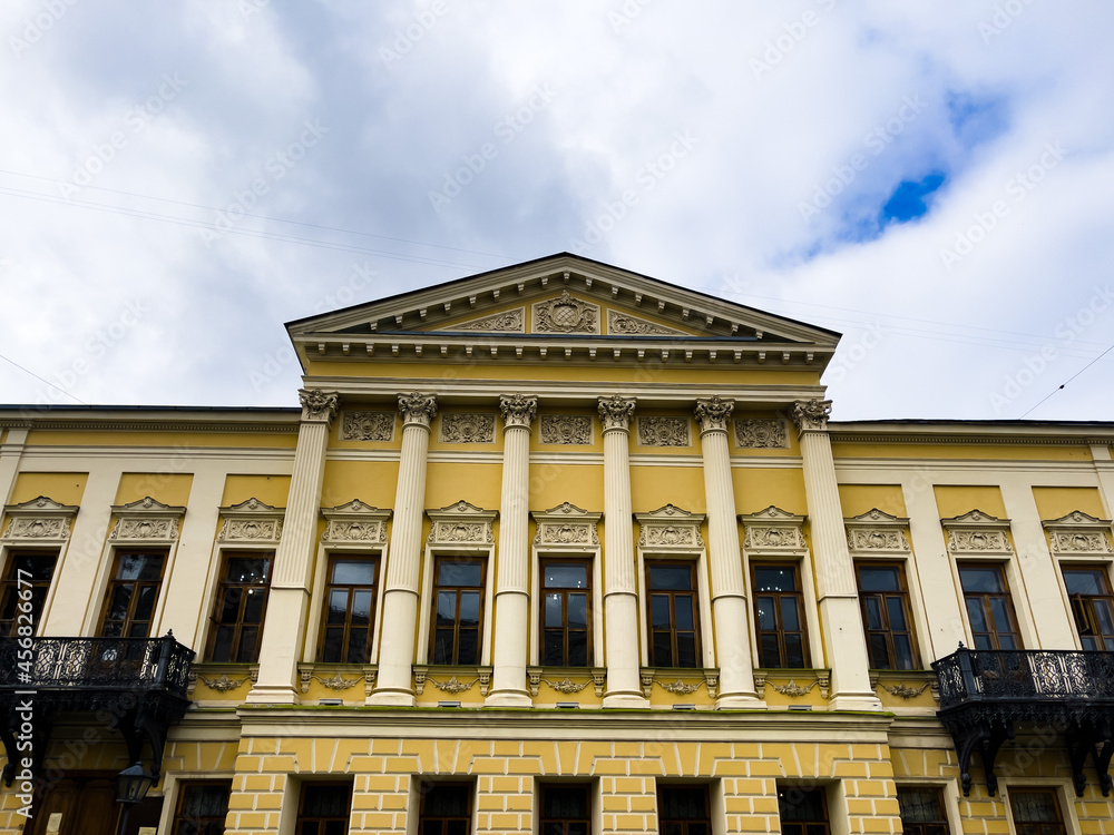 Facade of luxury. From below exterior of luxury mansion with many windows on sunny summer day