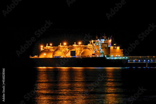 LNG tanker moored in the factory area at night.