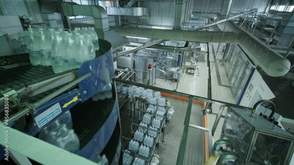 Modern strapping and transporting machine for packaging line at beverage plant Modern strapping and transporting machine for packaging line at beverage plant
