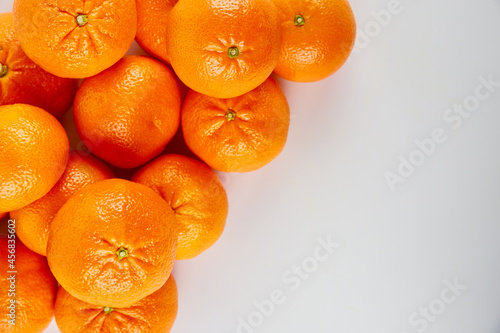 Ripe whole tangerines or mandarins on white background. photo