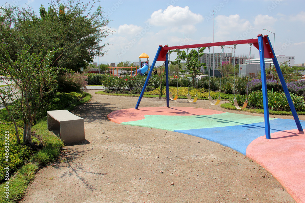 Color games for children in an open area between buildings, safe and quiet. There are swings, go up and down, slide and pass hands
