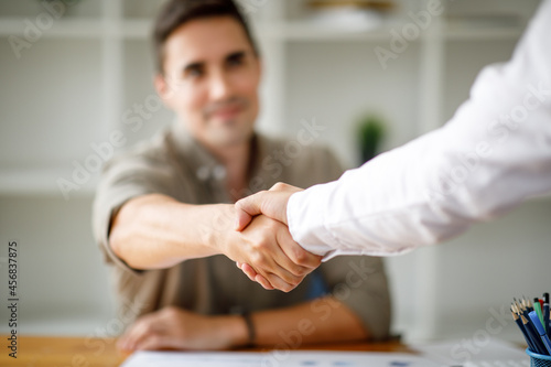 Business man offer and give hand for handshake in office. Successful job interview. Apply for loan in bank. Salesman, bank worker or lawyer shake for deal, agreement or sale. Increase of salary. photo