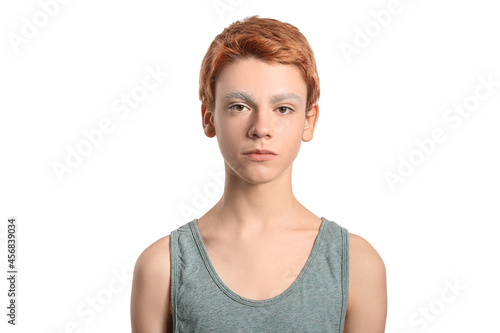 Teenage boy with dyed eyebrows on white background