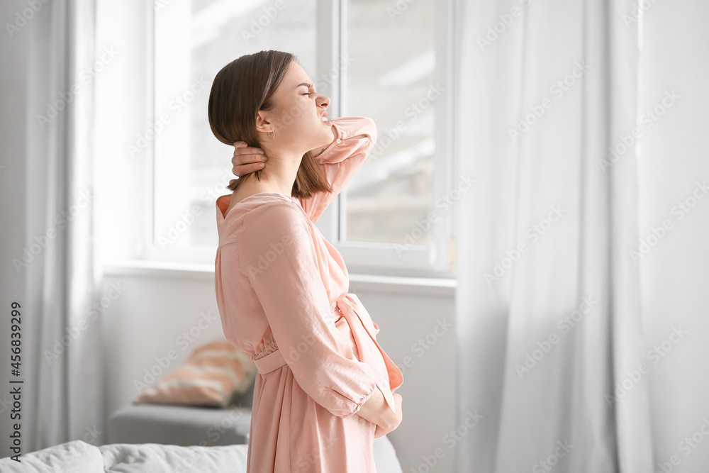 Young pregnant woman suffering from back pain at home Young pregnant woman suffering from back pain at home