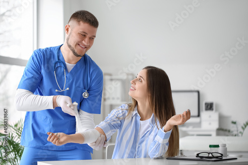 Doctor applying bandage ont...