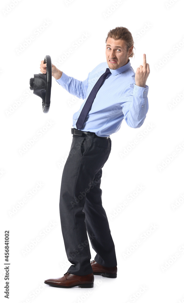 Young man with steering wheel showing middle finger on white background Young man with steering wheel showing middle finger on white background
