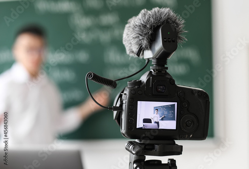 Asian teacher conducting En...