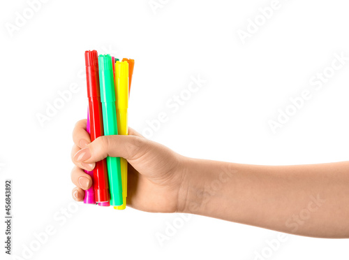 Woman holding colorful felt tip pens on white background