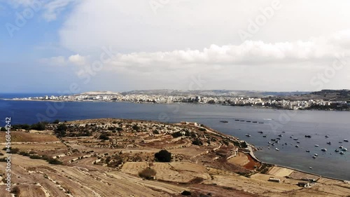 Beautiful aerial drone video from Malta, Mellieha, flying over Selmun with Saint Paul's Bay, Bugibba, Xemxija and Mistra Bay in the background. photo