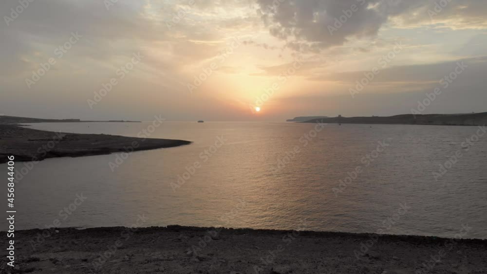 Romantic aerial drone video from north of Malta from Coral Lagoon area, showing the sea, Gozo and Comino in the background during sunset. Romantic aerial drone video from north of Malta from Coral Lagoon area, showing the sea, Gozo and Comino in the background during sunset.