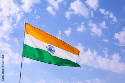 Waving flag of India on blue sky background photo