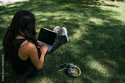 Girl working online from a park