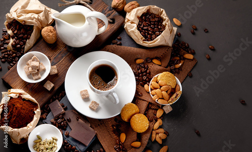 Coffee with snacks on black background.